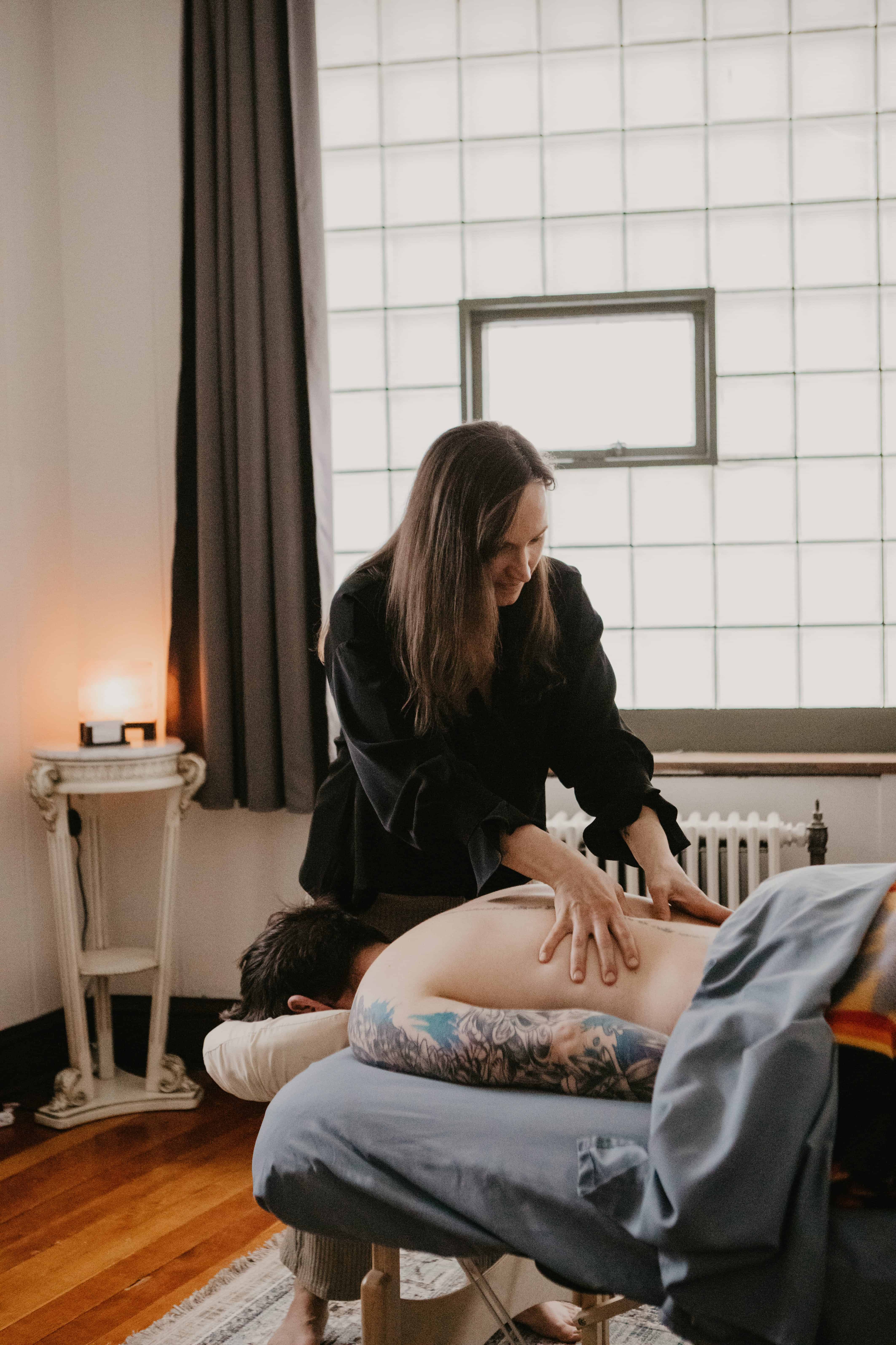 Leah Martinson gives a massage to her client to release trauma